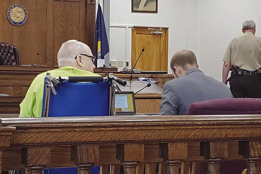 File - In this Aug. 13, 2019, file photo, James Jensen, 79, waits alongside his attorney Garret Wilson during a court hearing in Miles City, Montana. Jensen was sentenced Wednesday, Aug. 28, 2019, to 20 years in prison for having child pornography on his computer. The sentence will run consecutive to a 12-year federal sentence for using the internet to coerce and entice male athletes at Custer County District High School into being sexually abused under the guise of improving their athletic performance. The statute of limitations to prosecute the actual abuse has expired, but 32 men have filed a civil lawsuit against Jensen and the school district. (Ashley Wise/Miles City Star via AP, File)