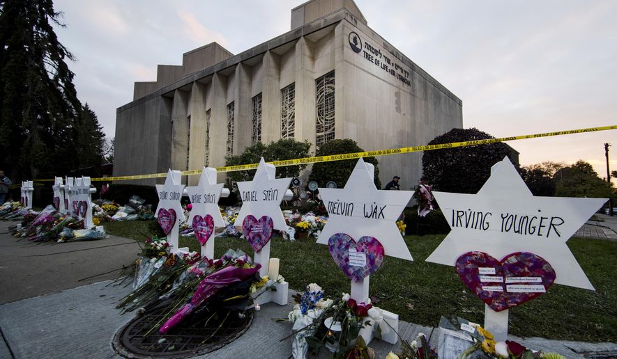 File - In this Monday, Oct. 29, 2018 file photo, a makeshift memorial stands outside the Tree of Life Synagogue in the aftermath of a deadly shooting in Pittsburgh. Federal prosecutors want a man accused of killing 11 people in a Pittsburgh synagogue to face a potential death sentence. The U.S. attorney's office in Pittsburgh filed a notice of intent Monday, Aug. 26, 2019 to seek the death penalty against 46-year-old Robert Bowers in last year's attack. (AP Photo/Matt Rourke, File)
