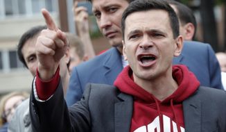 FILE In this file photo taken on Sunday, July 14, 2019, Russian opposition candidate Russian and activist Ilya Yashin gestures while speaking to a crowd during a protest in Moscow, Russia. A prominent Russian opposition figure has been detained by police immediately after leaving a jail where he had served two sentences connected to protests in Moscow. (AP Photo/Pavel Golovkin, File)