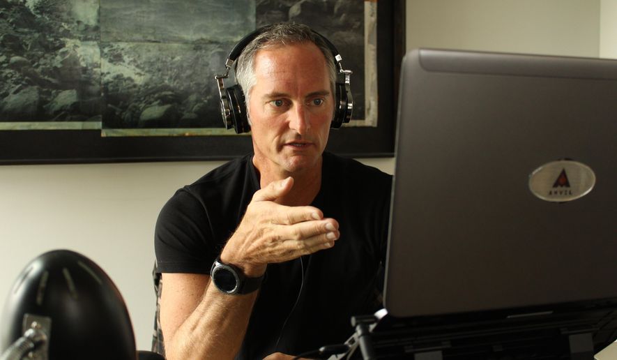 In this April 4, 2018 photo provided Anvil Media, Kent Lewis works at his office at Anvil Media in Portland, Ore. Lewis, owner of digital marketing company Anvil Media, includes a clause in contracts saying late payments will be subject to a 10% interest charge. That heads off the majority of late payments, he estimates. (Mike Terry/Anvil Media via AP)