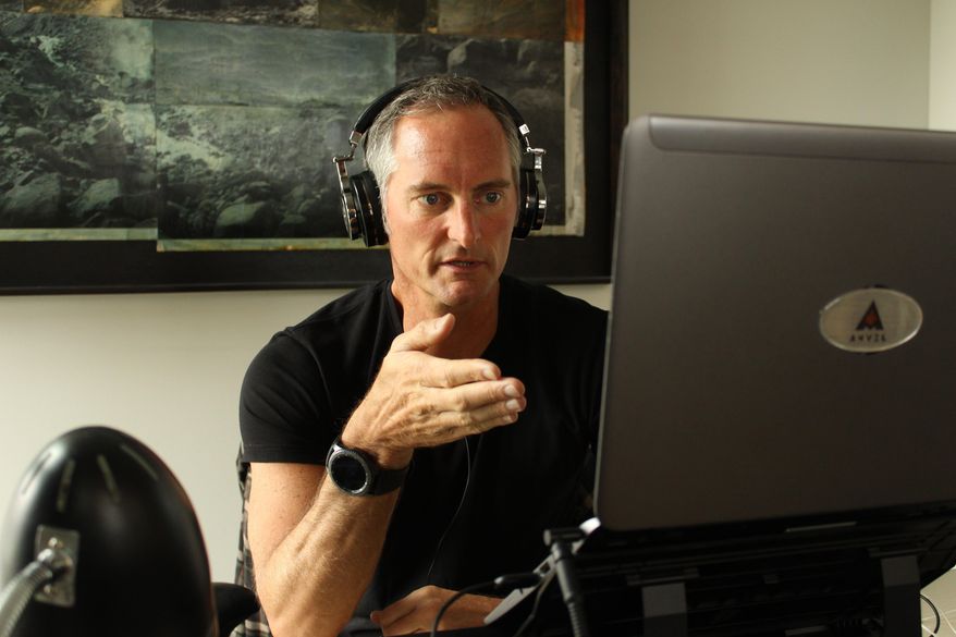 In this April 4, 2018 photo provided Anvil Media, Kent Lewis works at his office at Anvil Media in Portland, Ore. Lewis, owner of digital marketing company Anvil Media, includes a clause in contracts saying late payments will be subject to a 10% interest charge. That heads off the majority of late payments, he estimates. (Mike Terry/Anvil Media via AP)