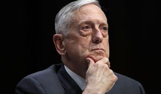 FILE - In this April 26, 2018, file photo, Defense Secretary Jim Mattis listens to a question during a hearing on Capitol Hill in Washington. Mattis warns bitter political divisions have pushed American society to the “breaking point” in his most extensive public remarks since he resigned in protest from the Trump administration.  (AP Photo/Jacquelyn Martin, File)