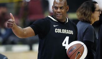 FILE - In this Thursday, March 7, 2019, file photo, Colorado head football coach Mel Tucker gestures to fans in the first half of an NCAA college basketball game as Colorado hosts UCLA in Boulder, Colo. Tucker will make his head coaching debut when he leads the Buffaloes on to the gridiron in Denver Friday night to face intrastate rival Colorado State. (AP Photo/David Zalubowski, File)
