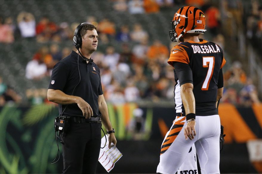 Cincinnati Bengals coach Zac Taylor, left, meets with quarterback Jake Dolegala (7) during the second half of the team's NFL preseason football game against the Indianapolis Colts, Thursday, Aug. 29, 2019, in Cincinnati. (AP Photo/Frank Victores)