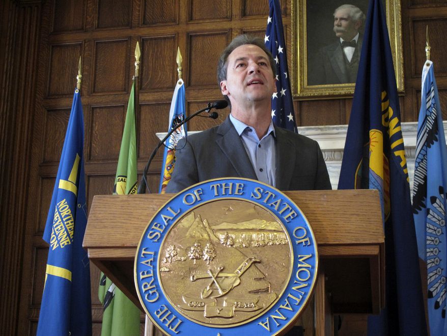 FILE - In this June 8, 2018 file photo, Montana Gov. Steve Bullock speaks before signing an executive order requiring major state government contractors to disclose any contributions to so-called "dark money" groups that aren't required to disclose their donors under federal election laws at the Capitol in Helena. A conservative advocacy group is challenging Bullock's executive order that requires organizations who receive state contracts to report political contributions that exceed $2,500, even if those disclosures aren't required under federal election laws. The federal court challenge was filed Tuesday, Aug. 27, 2019 by the Illinois Opportunity Group. (AP Photo/Matt Volz, File)
