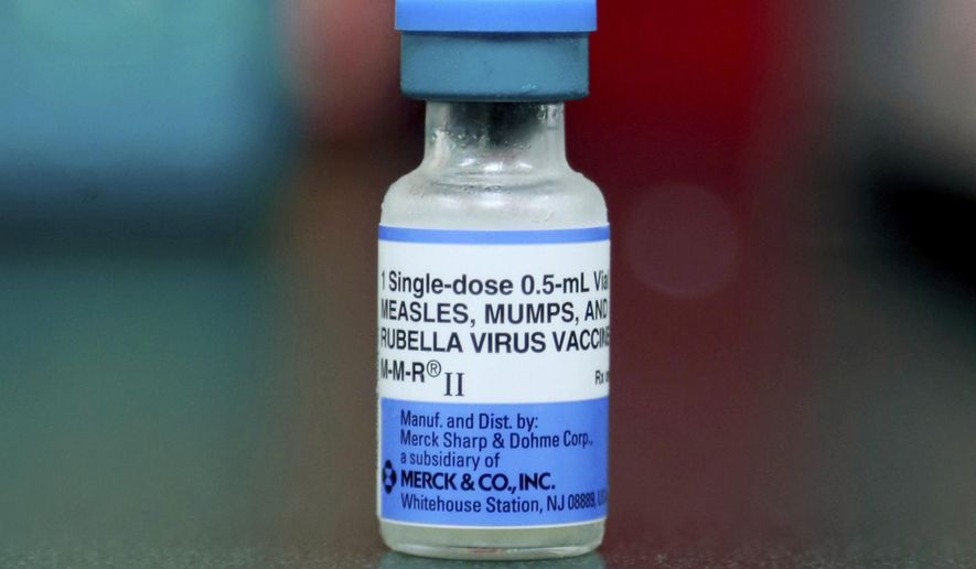 FILE - This Friday, May 17, 2019 file photo shows a vial of a measles, mumps and rubella vaccine in Mount Vernon, Ohio. On Thursday, Aug. 29, 2019, the first U.S. government report on mumps in migrant detention facilities say the virus has spread through 57 facilities in 19 states since September with new cases continuing as detainees are taken into custody or transferred. (AP Photo/Paul Vernon)
