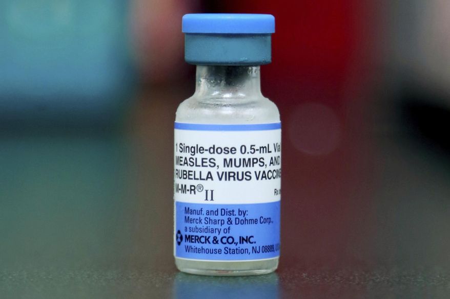 FILE - This Friday, May 17, 2019 file photo shows a vial of a measles, mumps and rubella vaccine in Mount Vernon, Ohio. On Thursday, Aug. 29, 2019, the first U.S. government report on mumps in migrant detention facilities say the virus has spread through 57 facilities in 19 states since September with new cases continuing as detainees are taken into custody or transferred. (AP Photo/Paul Vernon)