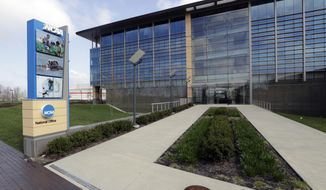FILE - This is an April 25, 2018, file photo showing NCAA headquarters in Indianapolis. The NCAA wants a level playing field for all athletes, even if state law proposals threaten its longtime model for amateur sports.With the California assembly considering a potentially landmark measure that would allow athletes at state colleges and universities to profit from the use of their names, likenesses and images, an NCAA working group is trying to figure out how to respond. (AP Photo/Darron Cummings, File)