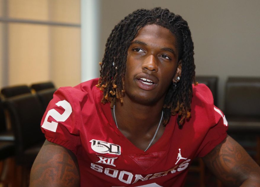 In this Friday, Aug. 2, 2019 photo, Oklahoma wide receiver CeeDee Lamb answers a question during an NCAA college football media day in Norman, Okla. Lamb is the next star receiver in the spotlight now that Marquise Brown is in the NFL. Lamb also will be a leader on a team with a lot of young receivers. (AP Photo/Sue Ogrocki)