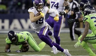 FILE - In this Dec. 10, 2018, file photo, Minnesota Vikings&#39; Adam Thielen (19) runs with the ball after a reception against the Seattle Seahawks in the second half of an NFL football game, in Seattle. Thielen’s Thursdays usually are busy. The star wide receiver has a full practice with the Minnesota Vikings as they implement their game plan for the upcoming opponent.Thielen’s football those days isn’t limited to working out with his teammates, though. This season, he’s hosting “Thursdays With Thielen,” which basically is a chili-fest across the nation focused on the cuisine of cities teams playing in the Thursday night game represent. (AP Photo/Stephen Brashear, File)