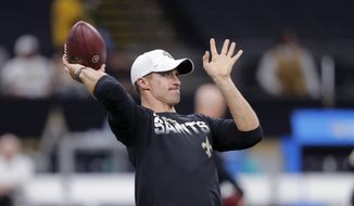 New Orleans Saints quarterback Drew Brees warms up before an NFL football game against the Miami Dolphins in New Orleans, Thursday, Aug. 29, 2019. (AP Photo/Bill Feig)