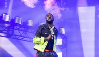 FILE - In this Sunday, Aug. 4, 2019 file photo, Meek Mill performs on day four of Lollapalooza in Grant Park in Chicago. The NFL and Roc Nation announced Friday, Aug. 30, 2019, that Mill and Rapsody will perform in a free pregame concert Sept 5 before the season-opening game between the Green Bay Packers and Chicago Bears. The concert is an early sign of how the league’s new social justice partnership with rapper Jay-Z and his label may work out. (Photo by Amy Harris/Invision/AP, File)