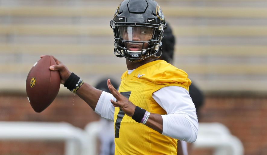 FILE - In this Aug. 12, 2019, file photo, Missouri quarterback Kelly Bryant throws during the NCAA college football team's practice in Columbia, Mo. Missouri plays at Wyoming this week. Bryant led Clemson to the 2017 national championship game before losing his job to Trevor Lawrence after four games last season. At Missouri, he’ll be asked to replace Drew Lock, who accounted for 12,193 yards and 99 touchdowns over his career and led the Tigers to bowl games each of the past two years. (AP Photo/Jeff Roberson, File)