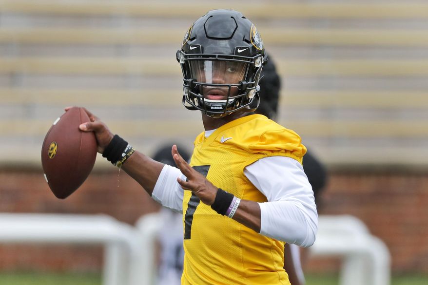 FILE - In this Aug. 12, 2019, file photo, Missouri quarterback Kelly Bryant throws during the NCAA college football team's practice in Columbia, Mo. Missouri plays at Wyoming this week. Bryant led Clemson to the 2017 national championship game before losing his job to Trevor Lawrence after four games last season. At Missouri, he’ll be asked to replace Drew Lock, who accounted for 12,193 yards and 99 touchdowns over his career and led the Tigers to bowl games each of the past two years. (AP Photo/Jeff Roberson, File)