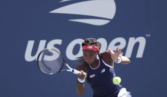 Coco Gauff, of the United States, returns a shot during a first round doubles match at the US Open tennis championships Friday, Aug. 30, 2019, in New York. (AP Photo/Kevin Hagen)