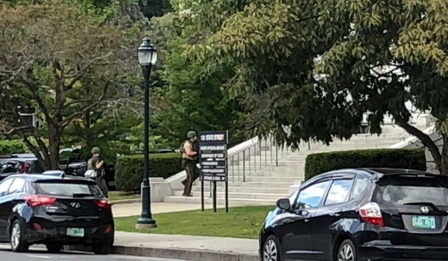 Police cars block off State Street in Montpelier, Vt., where state office buildings are in lockdown on Friday, Aug. 30, 2019. Some state government buildings are on lockdown in Vermont's Capitol complex after a report of a person with a weapon. State buildings Commissioner Christopher Cole tells WCAX News that there was a report from a member of the public that someone was seen going into the building that houses the tax department with what appeared to be a long gun. (AP Photo/Lisa Rathke)