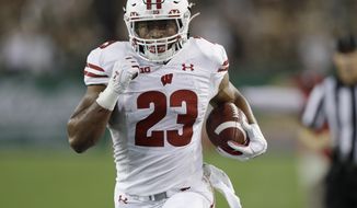 Wisconsin running back Jonathan Taylor (23) scores on a 37-yard tun against South Florida during the first half of an NCAA college football game Friday, Aug. 30, 2019, in Tampa, Fla. (AP Photo/Chris O&#39;Meara)
