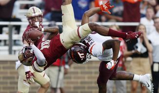 Boston College defensive back Brandon Sebastian (10) intercepts the pass intended for Virginia Tech wide receiver Phil Patterson during the second half of an NCAA college football game in Boston, Saturday, Aug. 31, 2019. (AP Photo/Michael Dwyer)