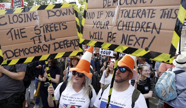 Anti Brexit protesters from &#x27;Stop the Coup&#x27; movement demonstrate outside Downing Street in London, Saturday, Aug. 31, 2019. Political opposition to Prime Minister Boris Johnson&#x27;s move to suspend Parliament is crystalizing, with protests around Britain and a petition to block the move gaining more than 1 million signatures. (AP Photo/Alastair Grant)