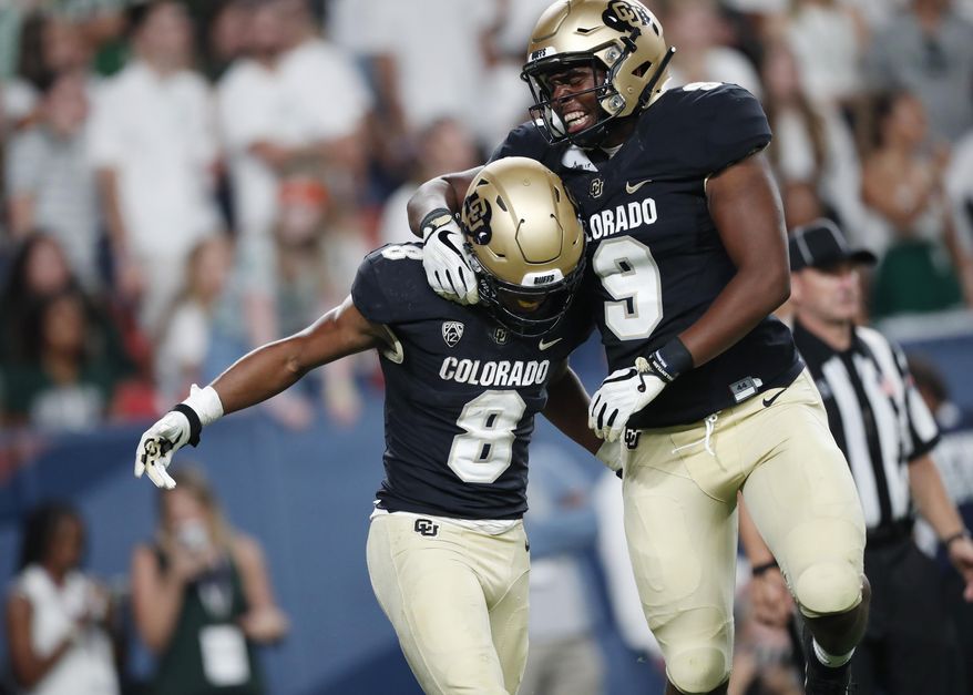 Colorado tight end Jalen Harris, right, celebrates with running back Alex Fontenot, who scored a touchdown against Colorado State in the third quarter of an NCAA college football game Friday, Aug. 30, 2019, in Denver. (AP Photo/David Zalubowski)