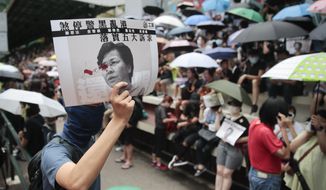 Protesters hold posters reading &amp;quot; Stop black police disrupting Hong Kong, implement five demands&amp;quot; as they attend a pro-democracy protest in Wan Chai, Hong Kong, Saturday, Aug. 31, 2019. Hundreds of people are rallying in an athletic park in central Hong Kong as a 13th-straight weekend of pro-democracy protests gets underway. (AP Photo/Jae C. Hong)