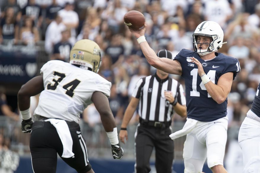 Penn State quarterback Sean Clifford (14) passes over Idaho linebacker Leo Tamba (34) during the 2nd quarter of an NCAA college football game in State College, Pa., on Saturday, Aug. 31, 2019. (AP Photo/Barry Reeger)