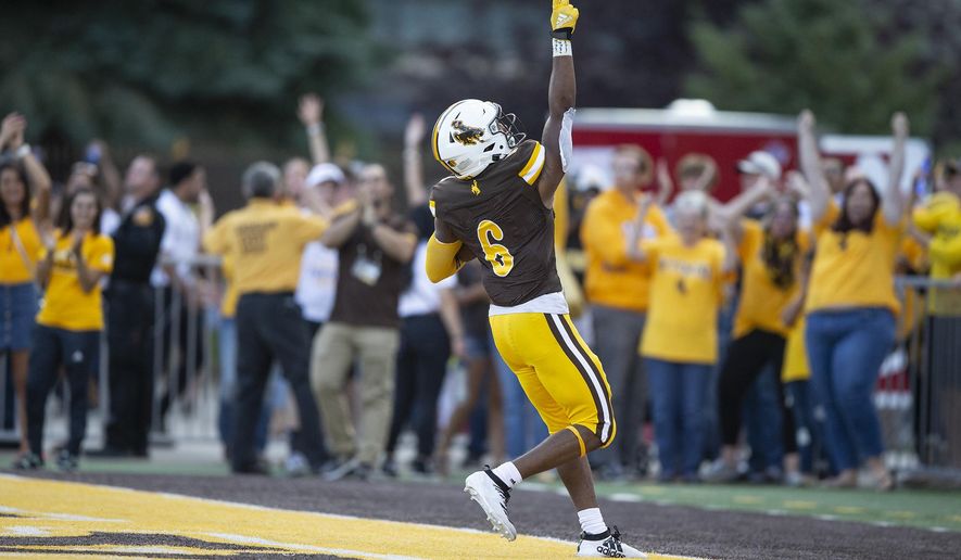 Wyoming running back Xazavian Valladay celebrates a touchdown run against Missouri during the second quarter of an NCAA college football game Saturday, Aug. 31, 2019, in Laramie, Wy. (AP Photo/Michael Smith)