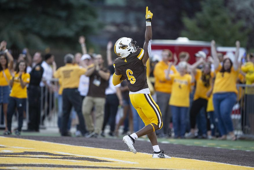 Wyoming running back Xazavian Valladay celebrates a touchdown run against Missouri during the second quarter of an NCAA college football game Saturday, Aug. 31, 2019, in Laramie, Wy. (AP Photo/Michael Smith)