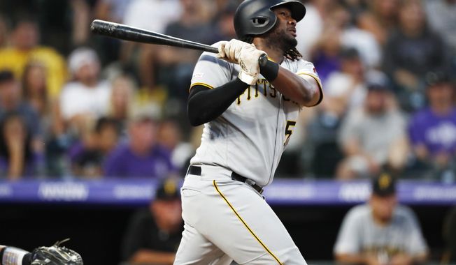 Pittsburgh Pirates&#x27; Josh Bell follows the flight of his solo home run off Colorado Rockies relief pitcher Wes Parsons in the fourth inning of a baseball game, Saturday, Aug. 31, 2019, in Denver. (AP Photo/David Zalubowski)