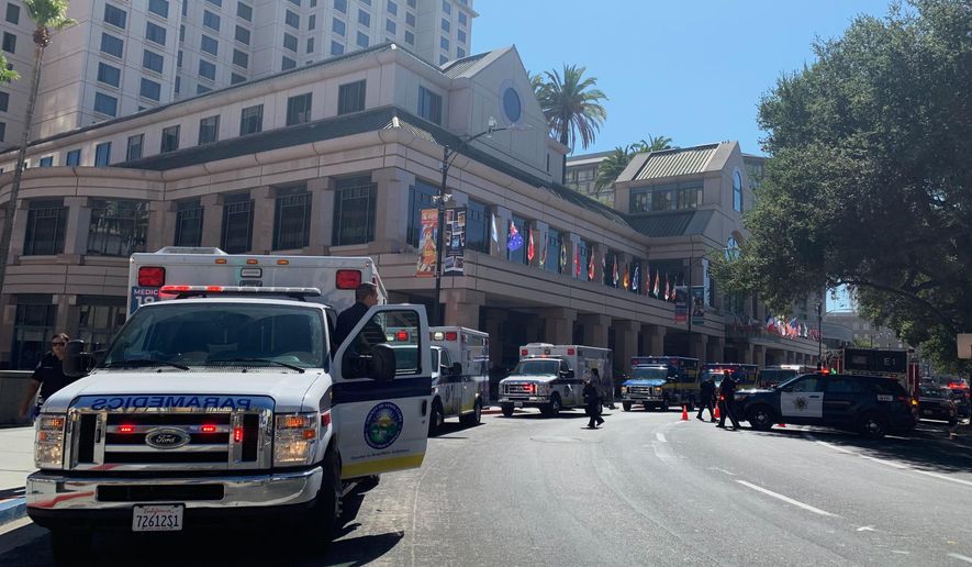 Fire crews gather on Market Street outside the Hotel Fairmont in downtown San Jose, Calif., after a report of a chemical odor Saturday, Aug. 31, 2019. Authorities say at least one woman has died and several people have been sickened in a hazmat incident Saturday at the Northern California hotel. (Nico Savidge/San Jose Mercury News via AP)