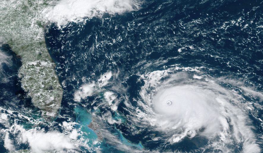 This GOES-16 satellite image taken Saturday, Aug. 31, 2019, at 16:00 UTC and provided by National Oceanic and Atmospheric Administration (NOAA), shows Hurricane Dorian, right, churning over the Atlantic Ocean. Hurricane Dorian bore down on the Bahamas as a fierce Category 4 storm Saturday, with new projections showing it curving upward enough to potentially spare Florida a direct hit but still threatening parts of the Southeast U.S. with powerful winds and rising ocean water that causes what can be deadly flooding.(NOAA via AP)