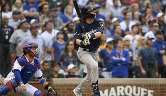 Milwaukee Brewers&#39; Christian Yelich watches his three-run home run during the ninth inning of a baseball game against the Chicago Cubs Sunday, Sept. 1, 2019, in Chicago. (AP Photo/Paul Beaty)