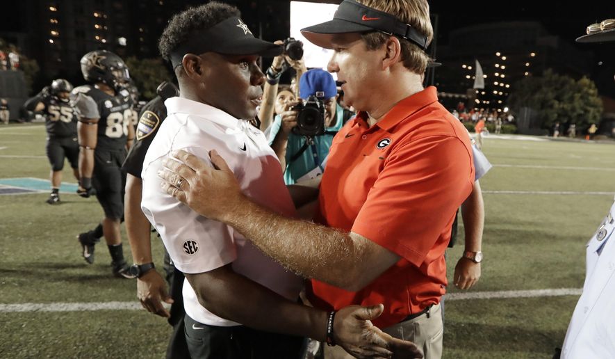 Vanderbilt head coach Derek Mason, left, congratulates Georgia head coach Kirby Smart after an NCAA college football game Saturday, Aug. 31, 2019, in Nashville, Tenn. (AP Photo/Mark Humphrey)