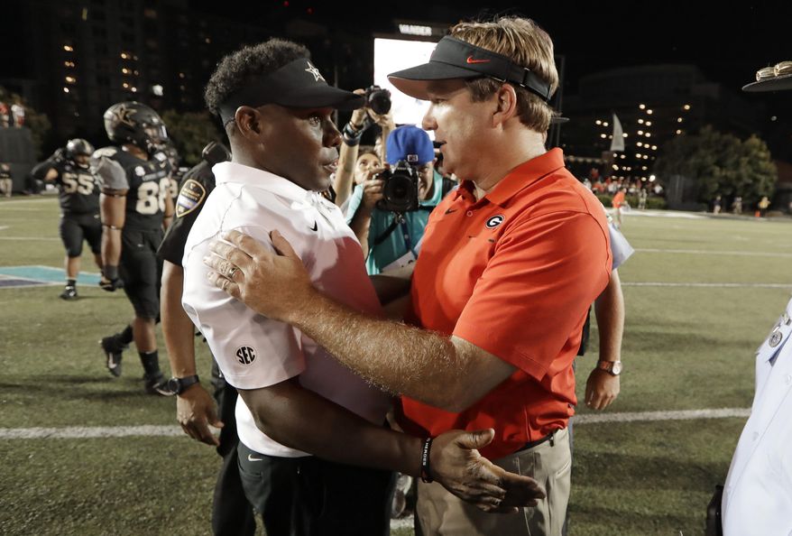 Vanderbilt head coach Derek Mason, left, congratulates Georgia head coach Kirby Smart after an NCAA college football game Saturday, Aug. 31, 2019, in Nashville, Tenn. (AP Photo/Mark Humphrey)