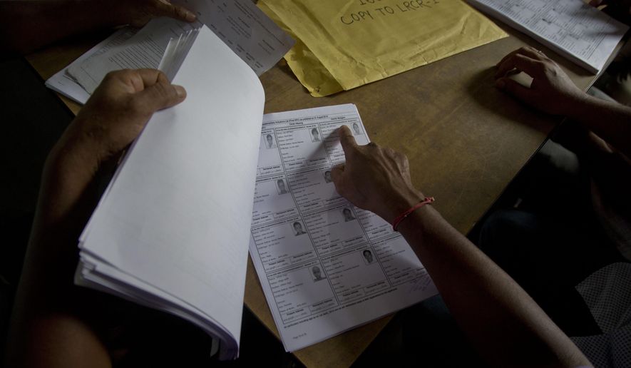 Villagers check their names in the final list of the National Register of Citizens (NRC) at an NRC center in Buraburi village in Morigaon district, in the northeastern Indian state of Assam, Saturday, Aug. 31, 2019. India has published the final citizenship list in the Indian state of Assam, excluding nearly two million people amid fears they could be rendered stateless. The list, known as the National Register of Citizens (NRC), intends to identify legal residents and weed out illegal immigrants from the state. (AP Photo/Anupam Nath)