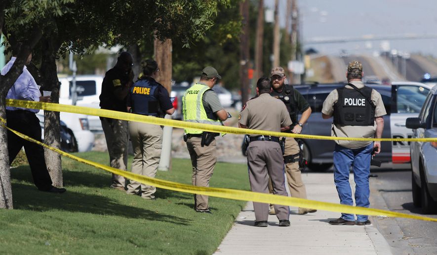 Authorities cordon off a part of the sidewalk in the 5100 block of E. 42nd Street in Odessa, Texas, Saturday, Aug. 31, 2019. (Mark Rogers/Odessa American via AP)