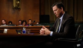 In this Wednesday, May 3, 2017, photo, then-FBI Director James B. Comey pauses as he testifies on Capitol Hill in Washington, before a Senate Judiciary Committee hearing. (AP Photo/Carolyn Kaster) ** FILE **