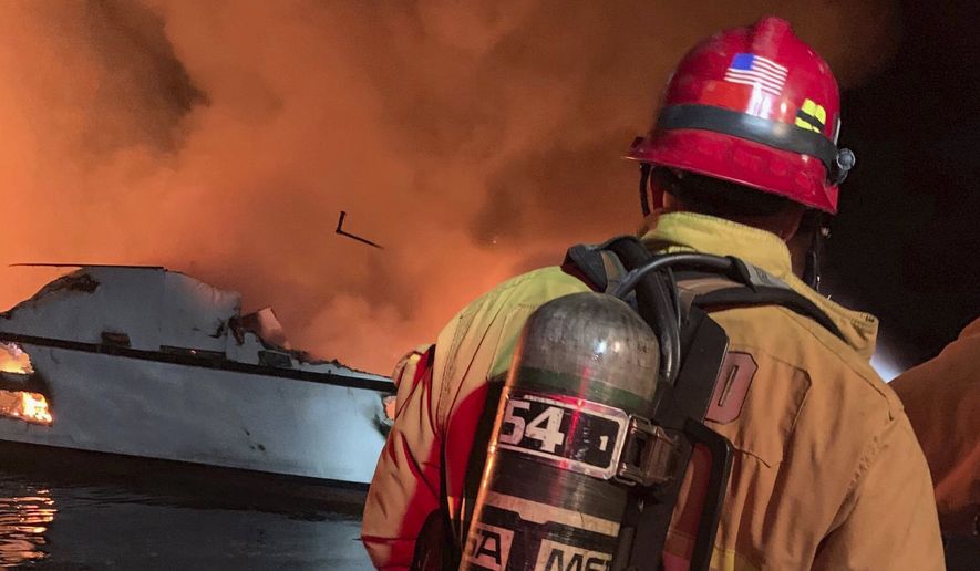 In this photo provided by the Ventura County Fire Department, VCFD firefighters respond to a boat fire off the coast of southern California, Monday, Sept. 2, 2019. The U.S. Coast Guard said it has launched several boats to help over two dozen people "in distress" off the coast of southern California. (Ventura County Fire Department via AP)