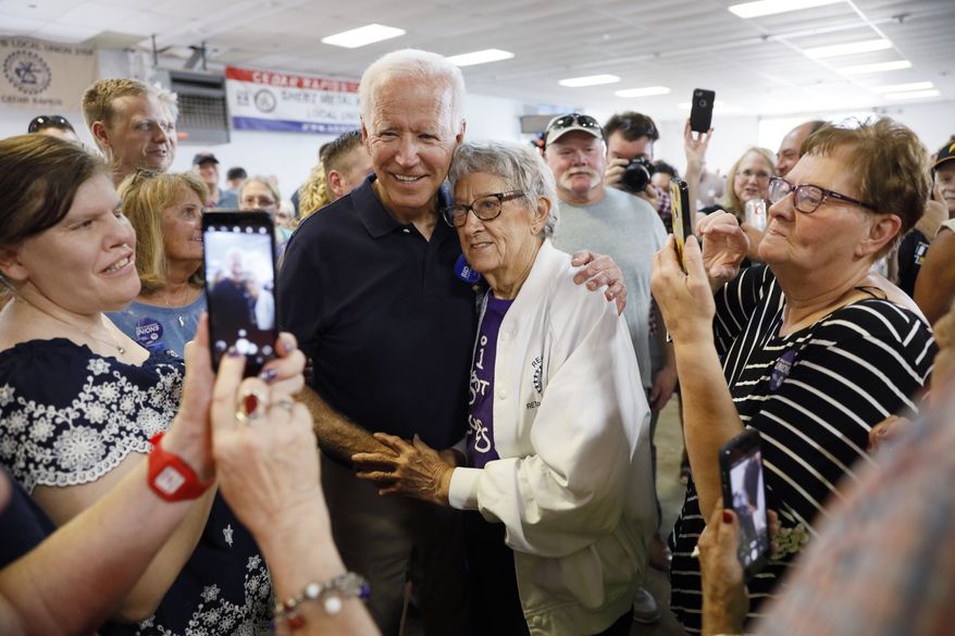 Democratic presidential candidate former Vice President Joe Biden gets a hug from Ruth Nowadzky, of Cedar Rapids, Iowa, during the Hawkeye Area Labor Council Labor Day Picnic, Monday, Sept. 2, 2019, in Cedar Rapids, Iowa. (AP Photo/Charlie Neibergall)
