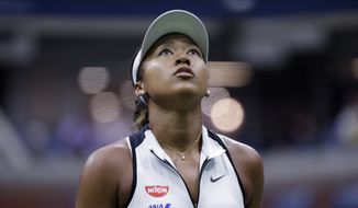 Naomi Osaka, of Japan, looks up at the score board during her match against Belinda Bencic, of Switzerland, in the fourth round of the US Open tennis championships Monday, Sept. 2, 2019, in New York. (AP Photo/Frank Franklin II)
