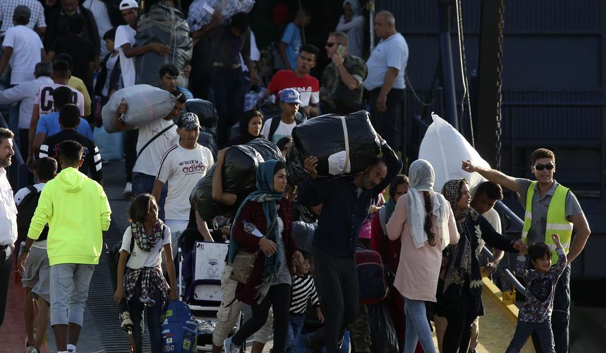 Refugees and migrants arrive at the port of Thessaloniki, northern Greece, Monday, Sept. 2, 2019. About 1,500 asylum-seekers were being transported from Greece's eastern Aegean island of Lesbos to the mainland Monday as part of government efforts to tackle massive overcrowding in refugee camps and a recent spike in the number of people arriving from the nearby Turkish coast. (AP Photo/Giannis Papanikos)