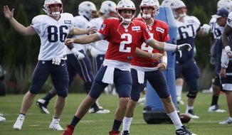 New England Patriots quarterbacks Brian Hoyer (2) and Jarrett Stidham (4) warm up along with and tight end Andrew Beck (86) at NFL football practice, Monday, Aug. 19, 2019, in Foxborough, Mass. (AP Photo/Elise Amendola)