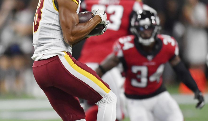 Washington Redskins wide receiver Josh Doctson (18) makes the catch against Atlanta Falcons defensive back Chris Cooper (34) during the first half an NFL preseason football game, Thursday, Aug. 22, 2019, in Atlanta. (AP Photo/Mike Stewart)