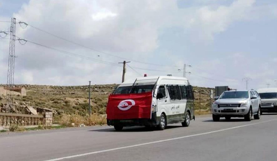 The convoy carrying the body of a slain Tunisian national guard head to is house in Kasserine Monday Sept.2, 2019. A Tunisian national guard chief and three extremists were killed in a clash Monday, on the first day of the country's presidential campaign, authorities said. (AP Photo/Mohamed Ben Salah)