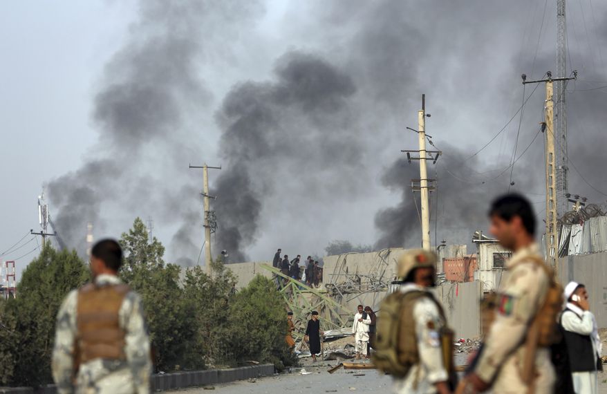 Smoke rises as Kabul residents set fire to part of the Green Village compound that has been attacked frequently, a day after a Taliban suicide attack in Kabul, Tuesday, Sept. 3, 2019. An interior ministry spokesman said some hundreds of foreigners were rescued after the attack targeted the compound, which houses several international organizations and guesthouses. (AP Photo/Rahmat Gul)
