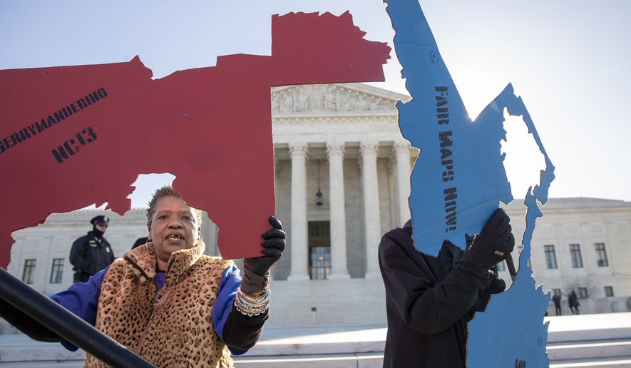 Activists at the Supreme Court opposed to partisan gerrymandering hold up representations of congressional districts from North Carolina, left, and Maryland, right, as justices hear arguments about the practice of political parties manipulating the boundary of a congressional district to unfairly benefit one party over another, in Washington, Tuesday, March 26, 2019. Democrats and Republicans eagerly await the outcome of cases from Maryland and North Carolina because a new round of redistricting will follow the 2020 census, and the decision could help shape the makeup of Congress and state legislatures over the next decade. (AP Photo/Carolyn Kaster)