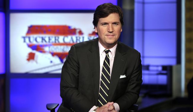 In this March 2, 2017, file photo, Tucker Carlson, host of &quot;Tucker Carlson Tonight&quot; poses for photos in a Fox News Channel studio in New York. (AP Photo/Richard Drew, File)