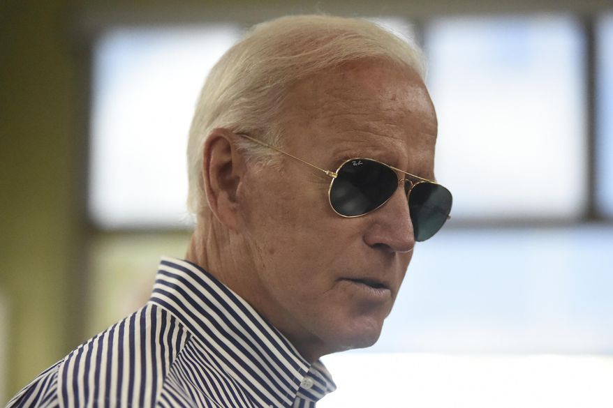 Democratic presidential candidate former Vice President Joe Biden pays for his order at a Krispy Kreme following a campaign town hall on Wednesday, Aug. 28, 2019, in Spartanburg, S.C. (AP Photo/Meg Kinnard) ** FILE **