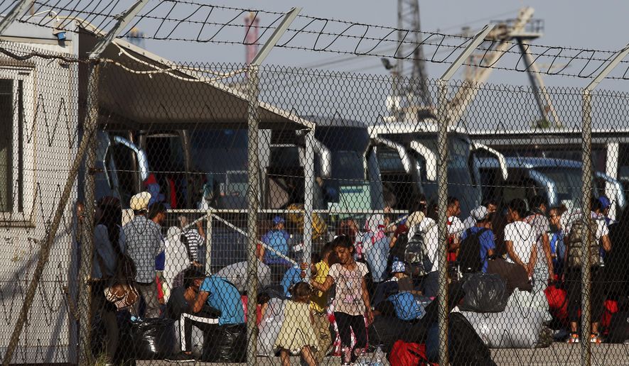 Refugees and migrants arrive at the port of Thessaloniki, northern Greece, Tuesday, Sept. 3, 2019. A ship carrying more than 780 asylum-seekers who had been in a camp on the eastern Aegean island of Lesbos has arrived in Greece's northern port of Thessaloniki, as part of government efforts to ease severe overcrowding and tackle a recent increase in new arrivals on the islands. (AP Photo/Giannis Papanikos)