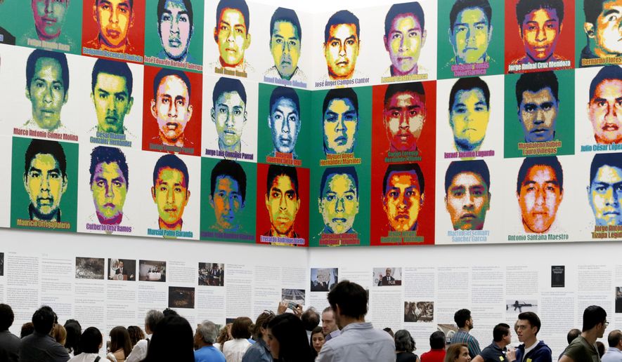 FILE - In this April 13, 2019 file photo, people stand under the portraits of 43 disappeared teachers’ college students, by Chinese concept artist and government critic Ai Weiwei at the Contemporary Art University Museum, in Mexico City. One of the main suspects in the 2014 disappearance of the students in Mexico has been acquitted, released from custody on Saturday, Aug. 31, 2019, as justice remains elusive for one of the darkest moments of the country’s recent history. (AP Photo/Claudio Cruz, File)